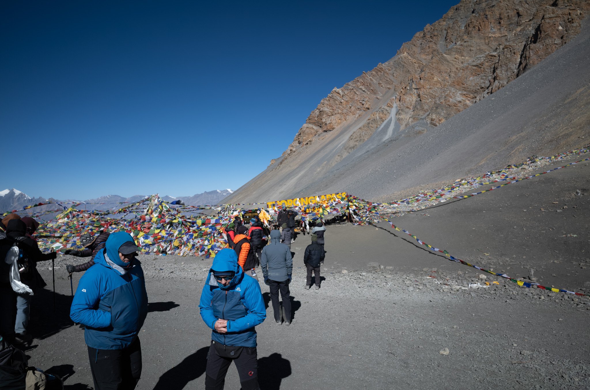 Foreign hikers and their guides at the top of the Thorong La pass on the Annapurna Circuit