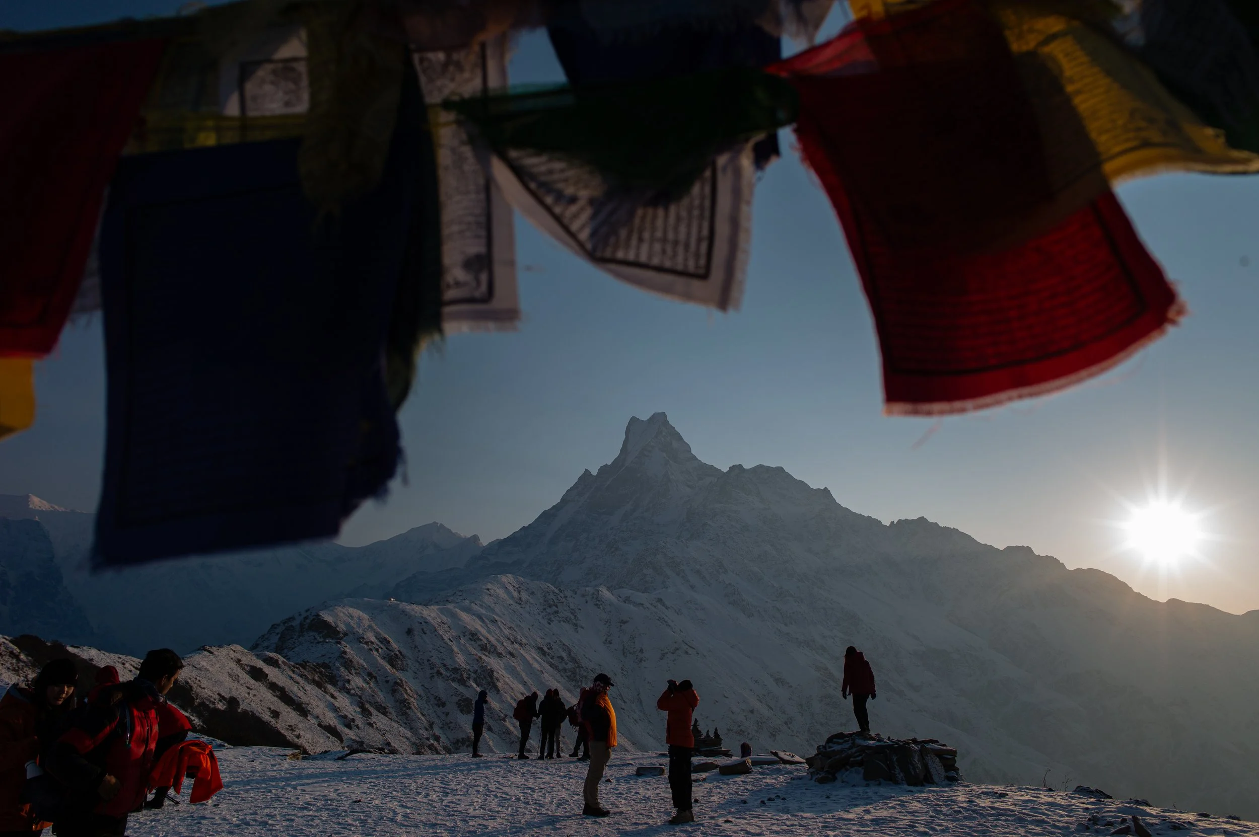 Hikers reach a high viewpoint at sunrise to catch views of Machhapuchhare and other Annapurna peaks