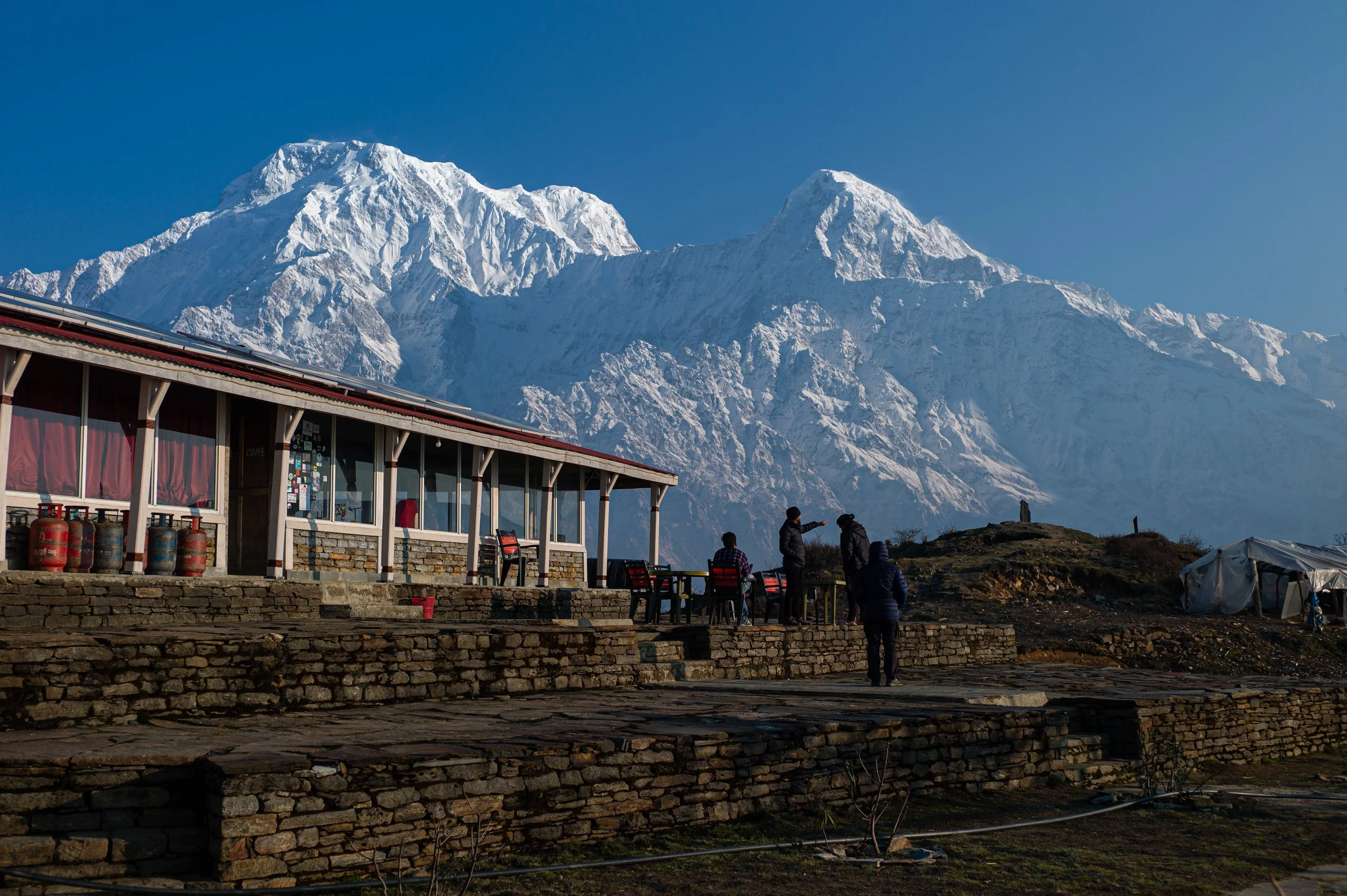 Hikers on the Mardi Himal Trek with Annapurna South and Hiunchuli in the background