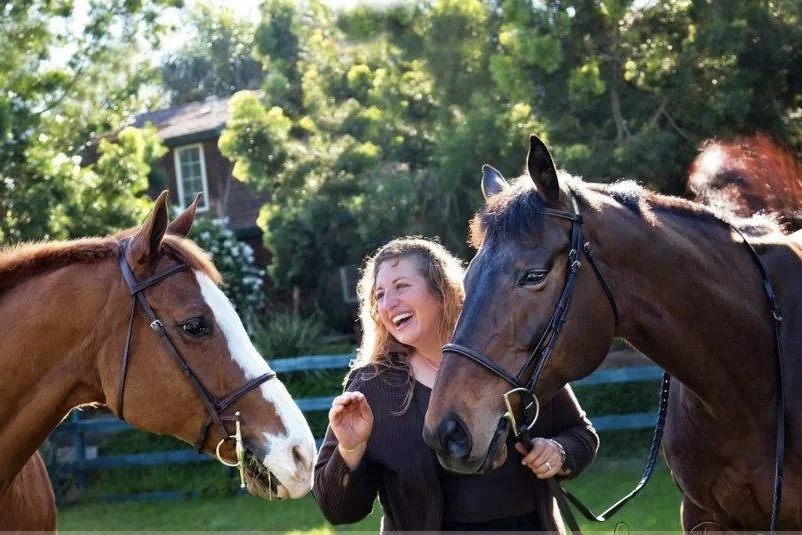 Rescued horses building connection and trust with a volunteer at Rising Phoenix Thoroughbred Rescue