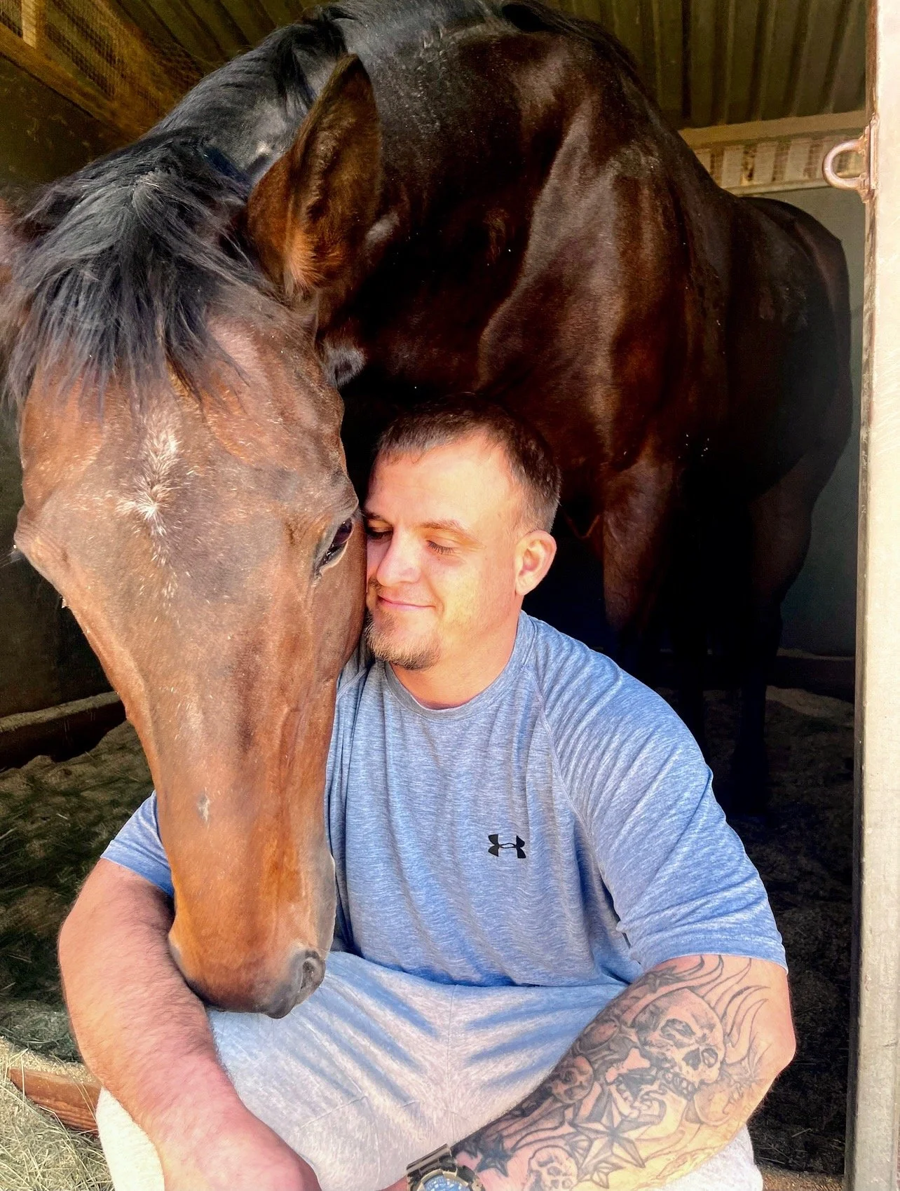 Recovery program participant connecting with a rescued horse at Rising Phoenix Thoroughbred Rescue