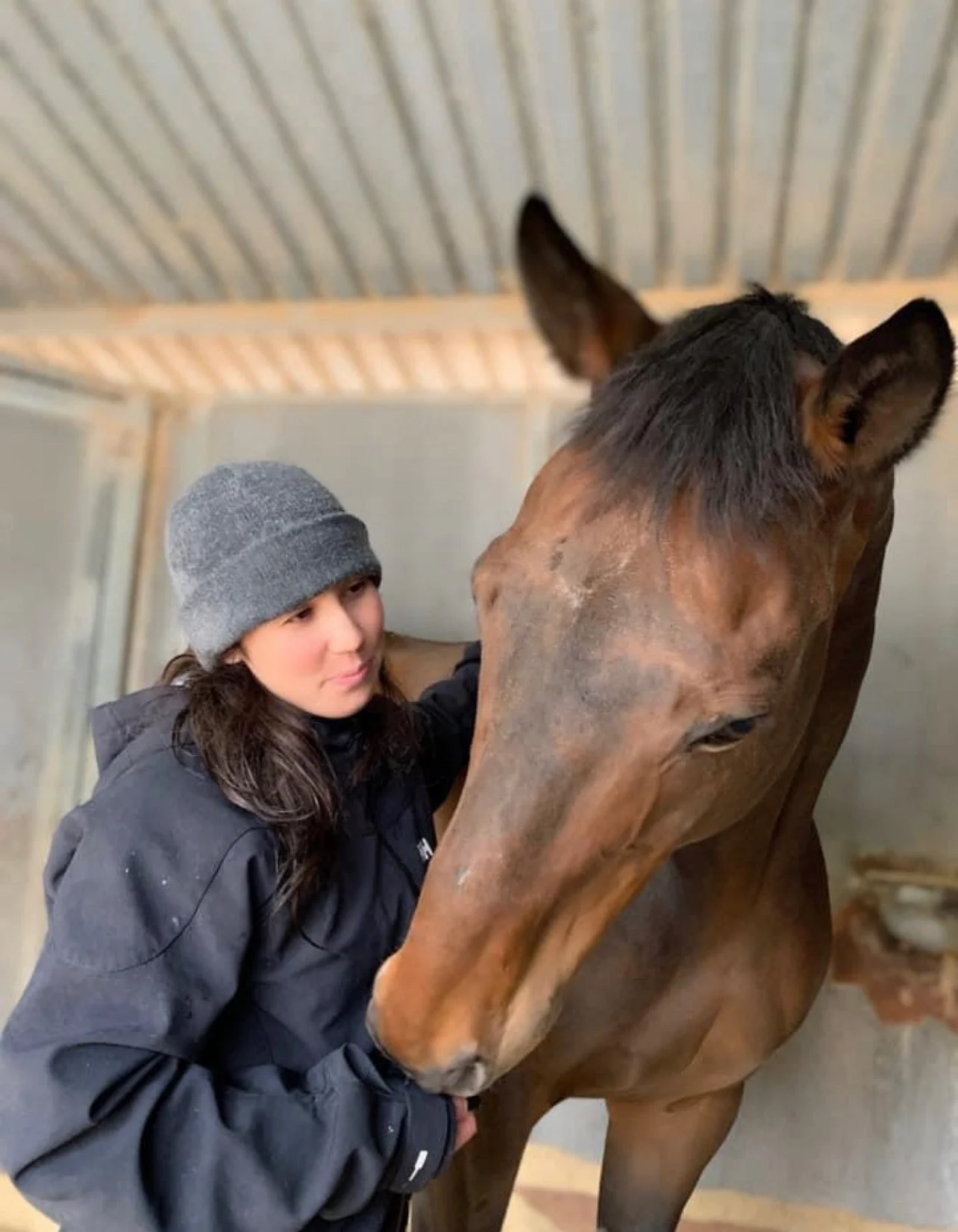 A quiet moment of trust and connection with a. rescued horse at Rising Phoenix Thoroughbred Rescue.