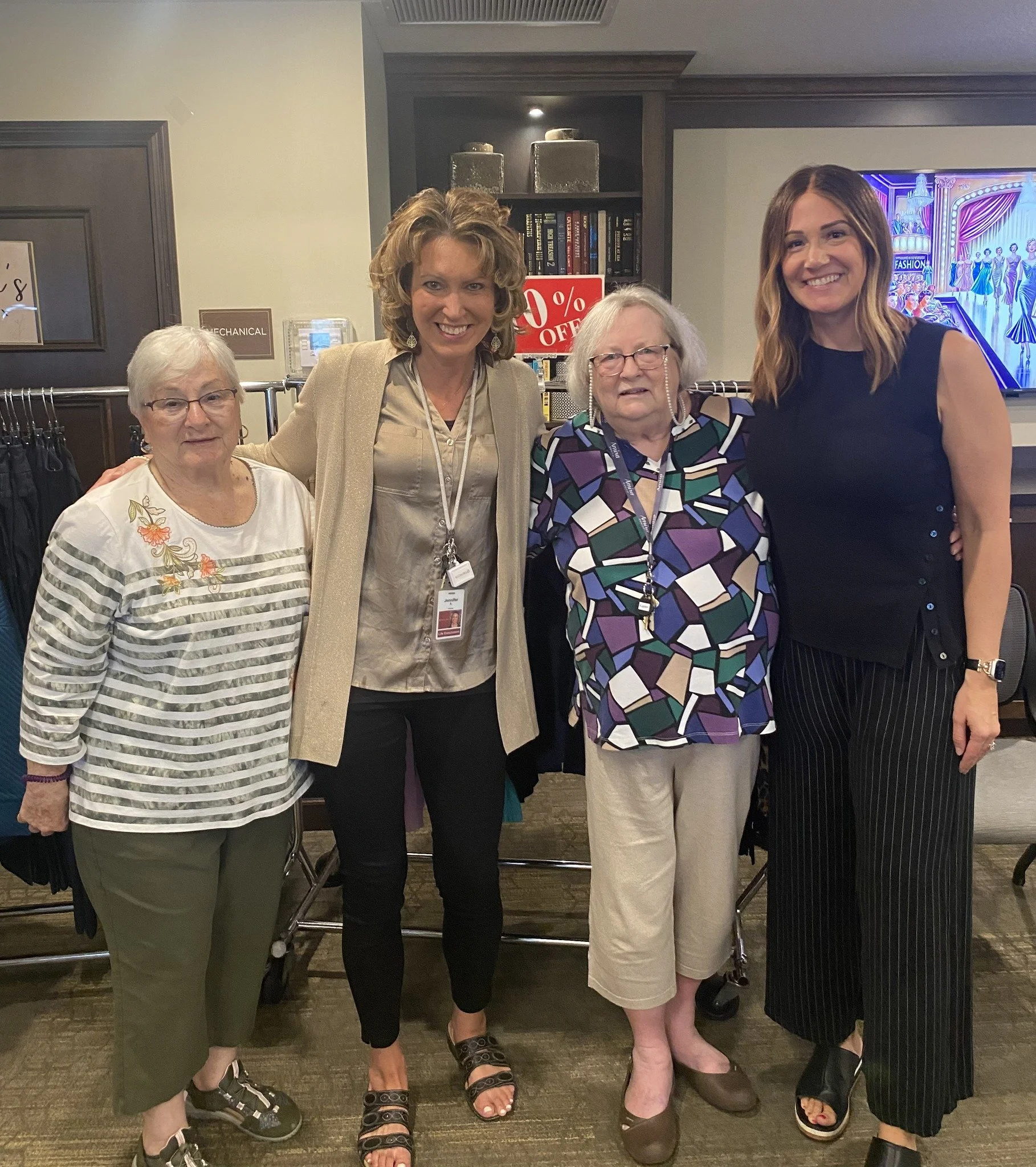 Chosen Threads Boutique owner Nicole Steckler posing with three clients.