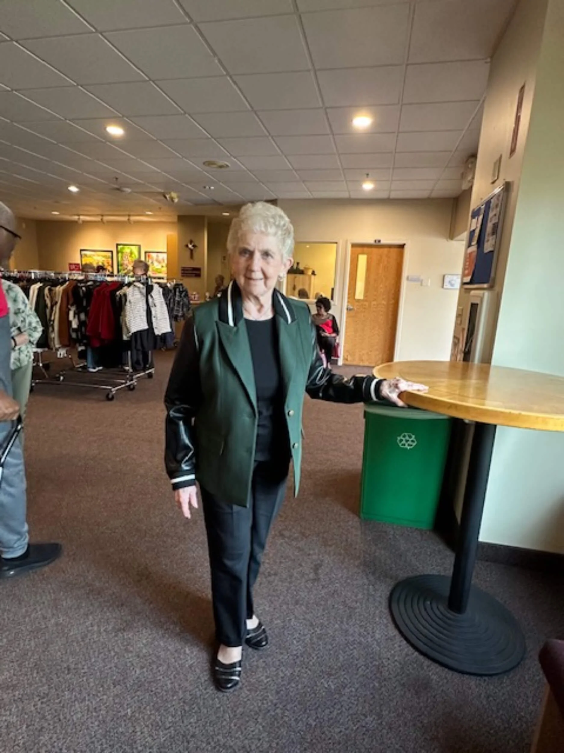 Chosen Threads Boutique model in green jacket.