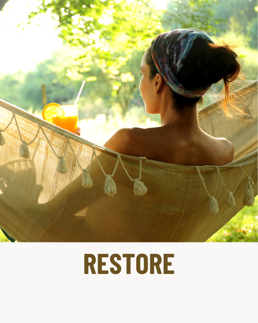 A woman relaxing in a hammock outdoors drinking orange juice with a lemon slice, surrounded by lush green trees.