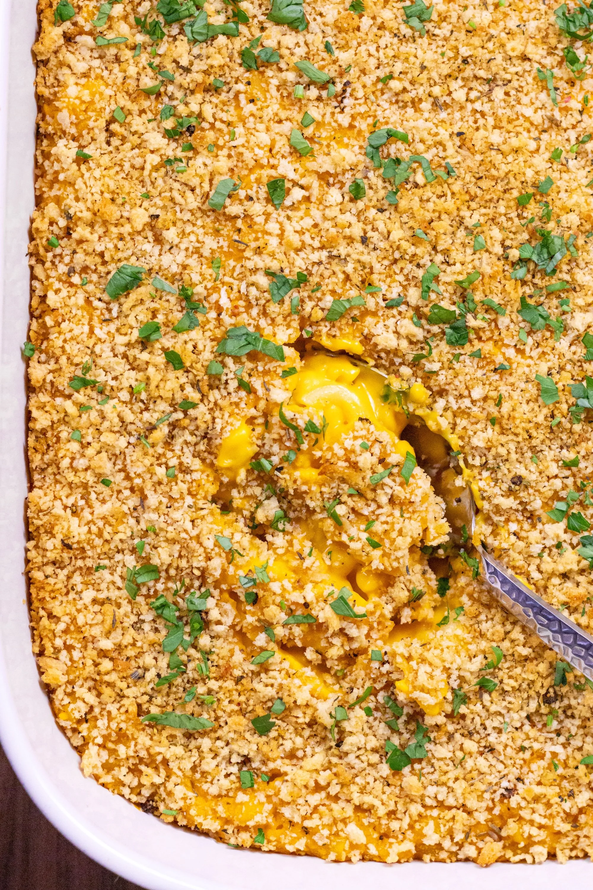 Baked vegan butternut squash mac and cheese topped with golden breadcrumbs and parsley.