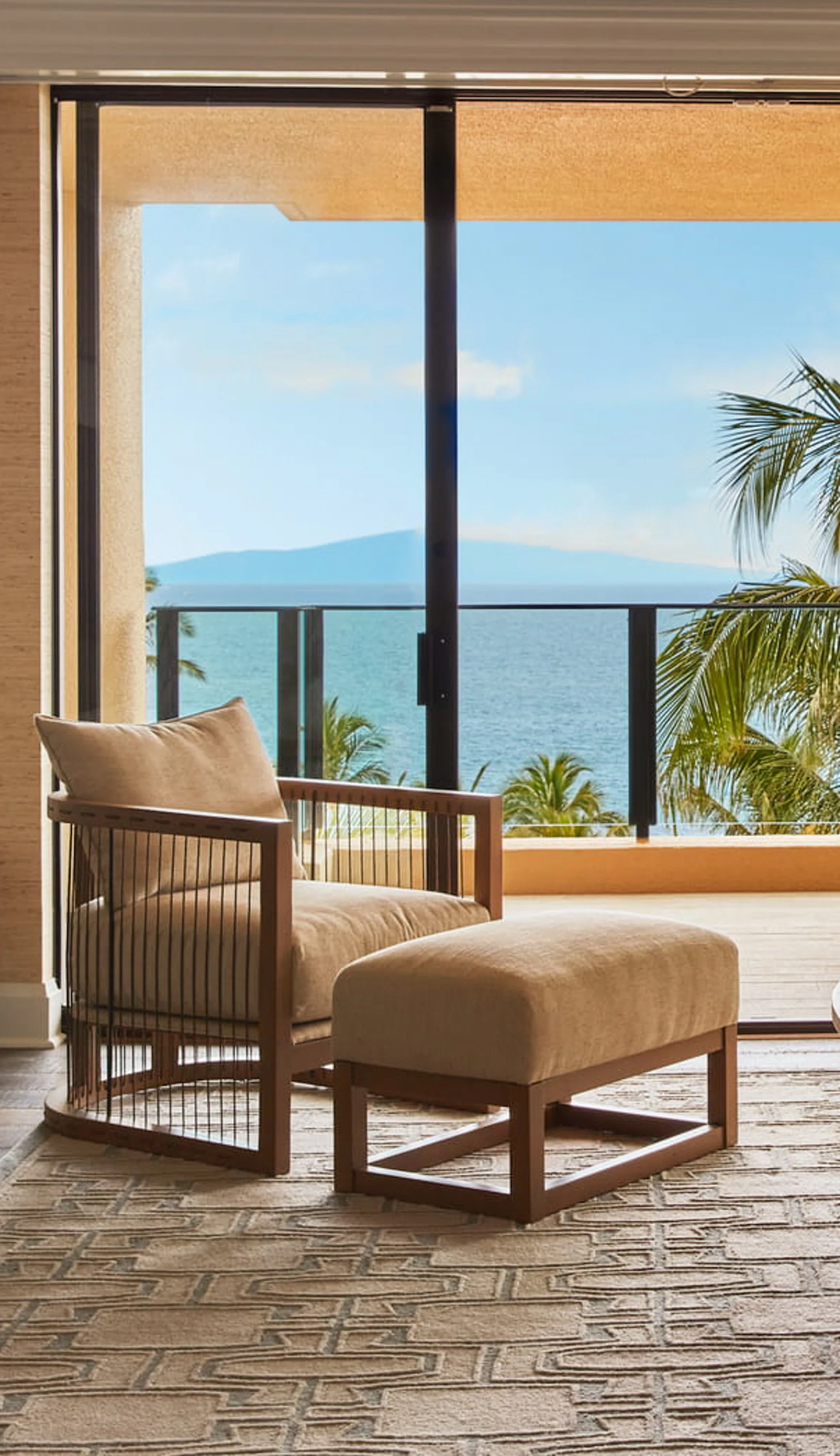 ocean view from a Wailea accommodation with lounge seating and palm trees