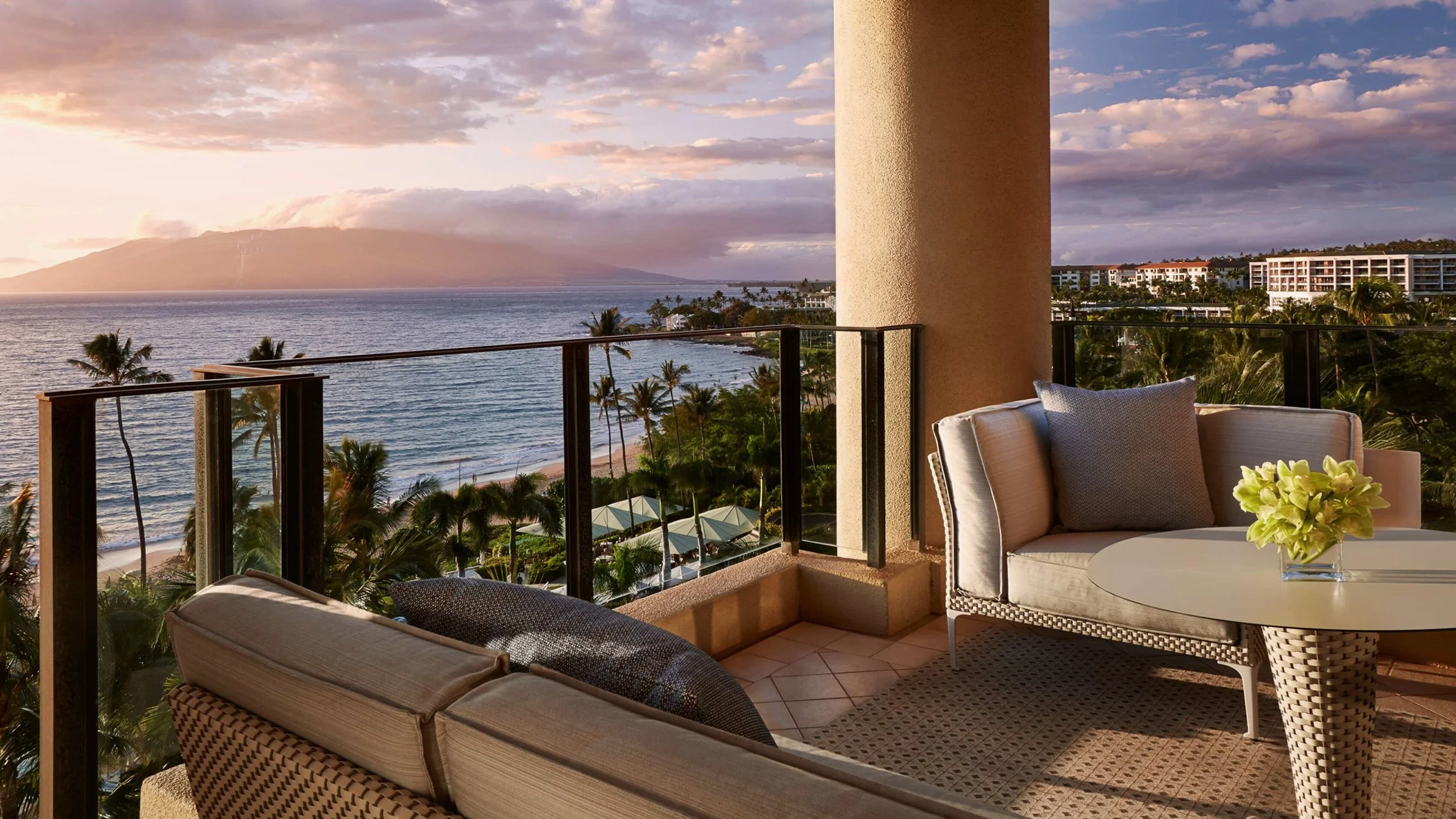 ocean view from a Wailea resort balcony with palm trees and West Maui Mountains
