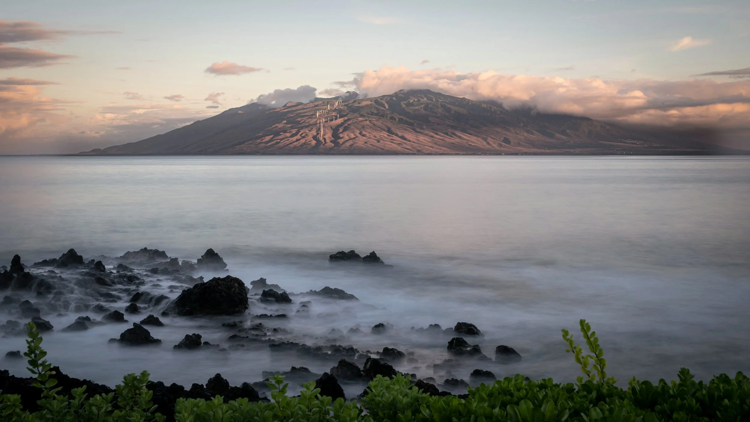 view of the West Maui Mountains from the Wailea coastline at sunset