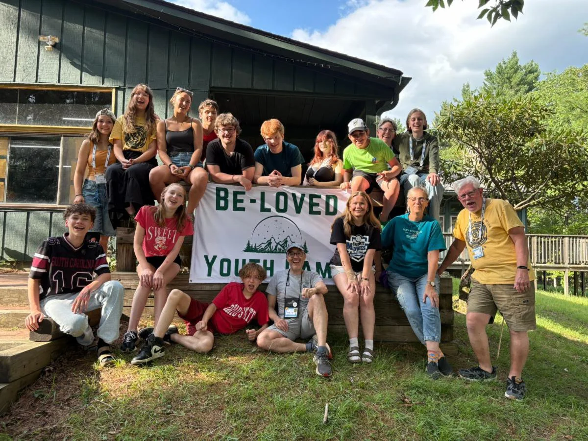 Youth with sign from Be-Loved Youth Camp