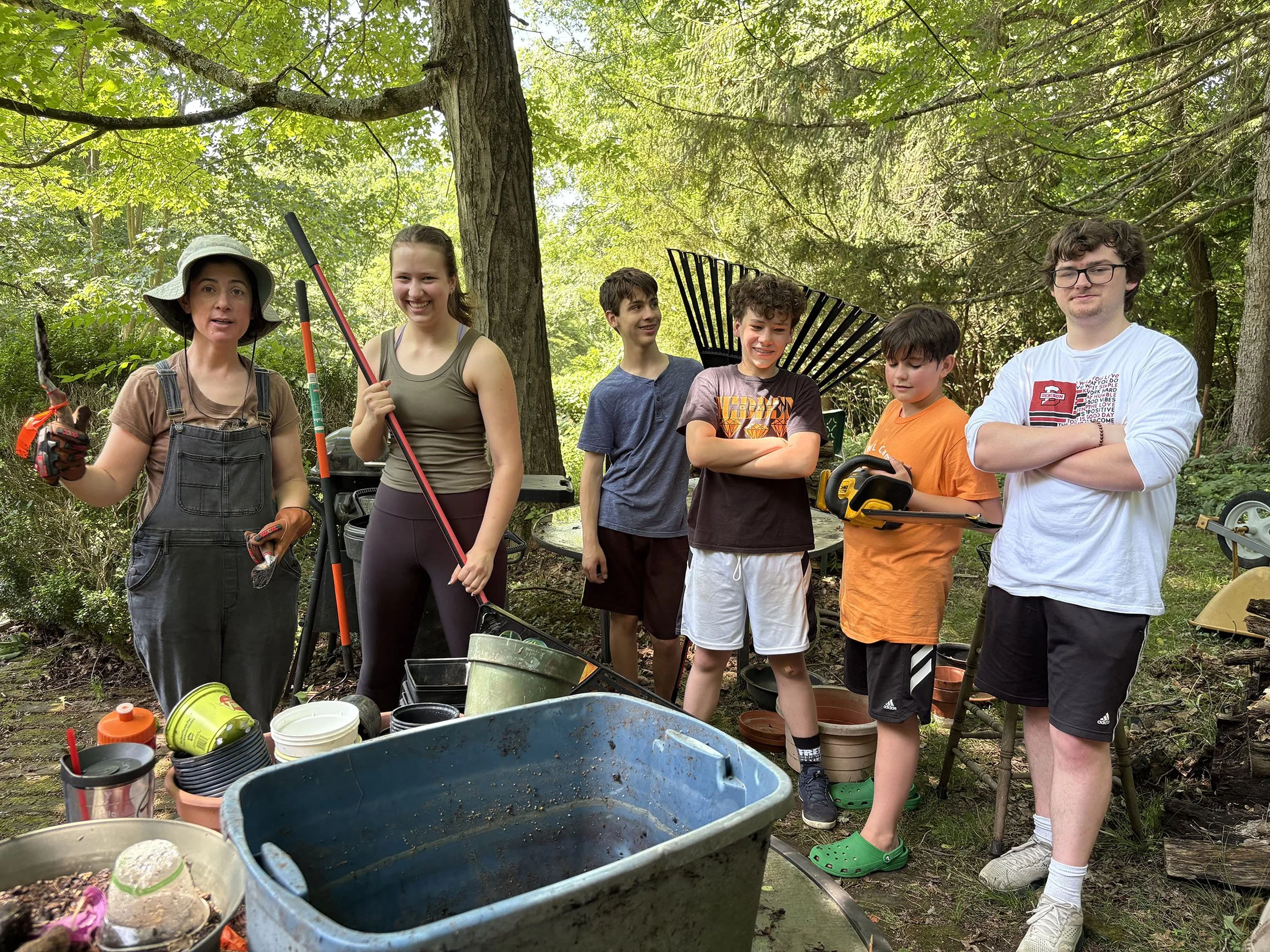 youth group with rakes doing yard work for person who cannot do it
