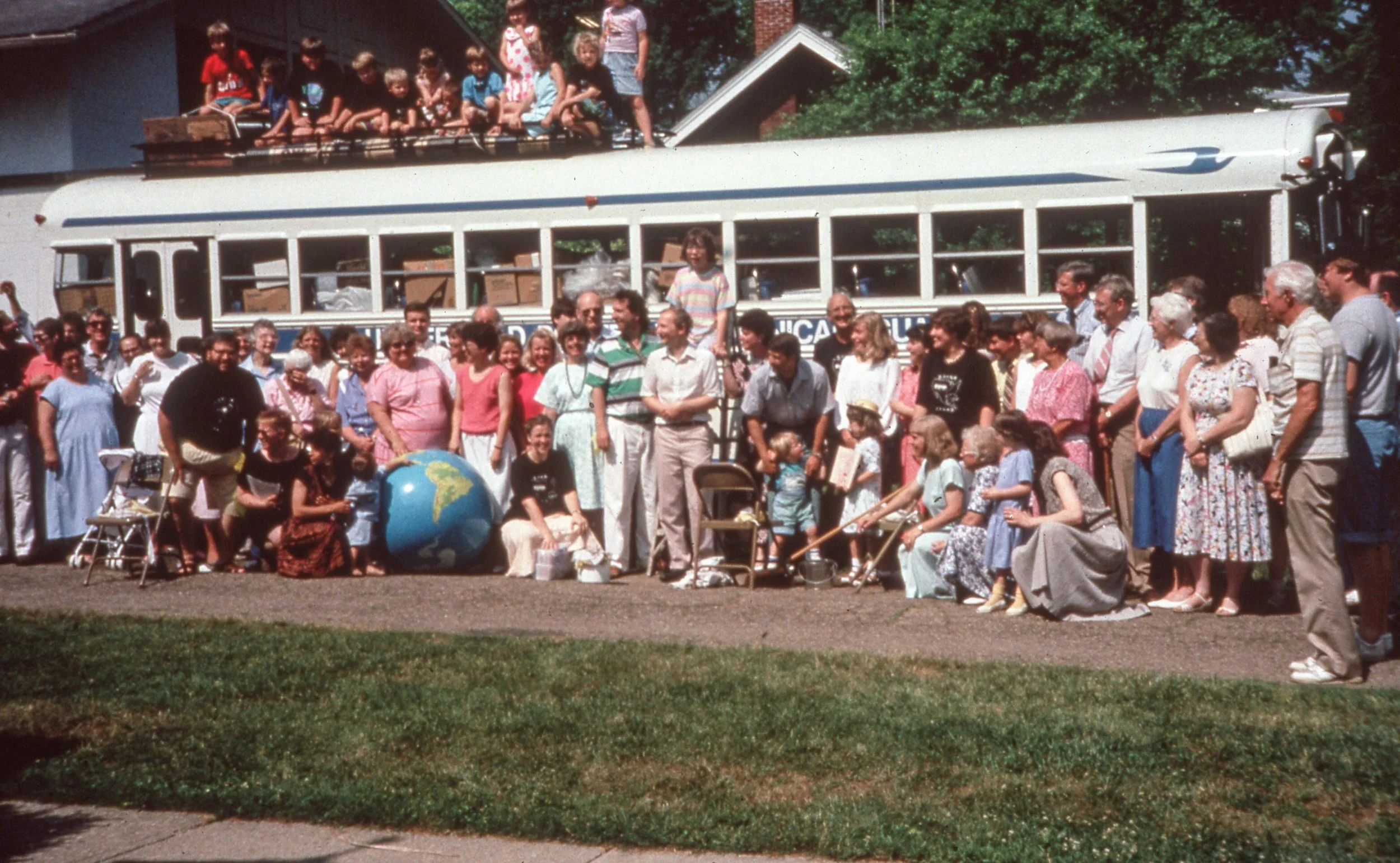 white bus as a gift to Universidad Polytechnical Managua Nicaragua with people from church standing in front of it before the drivers left