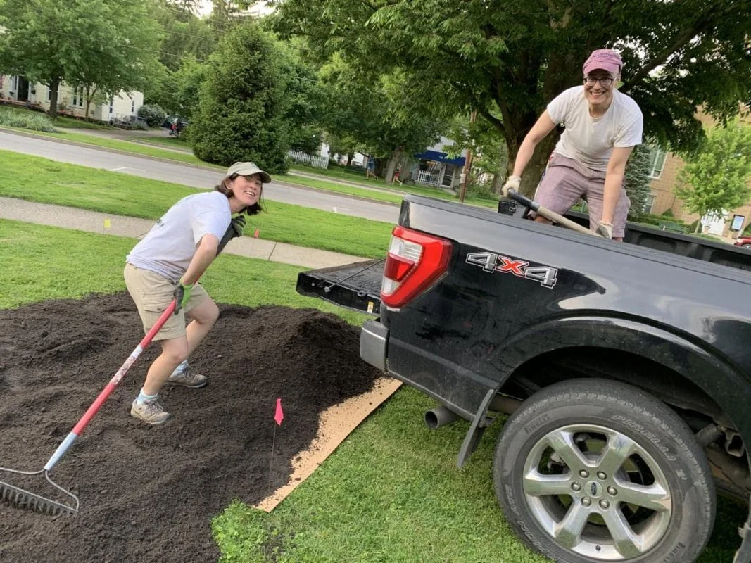 creating the pollinator garden on our front lawn, raking and shoveling dirt