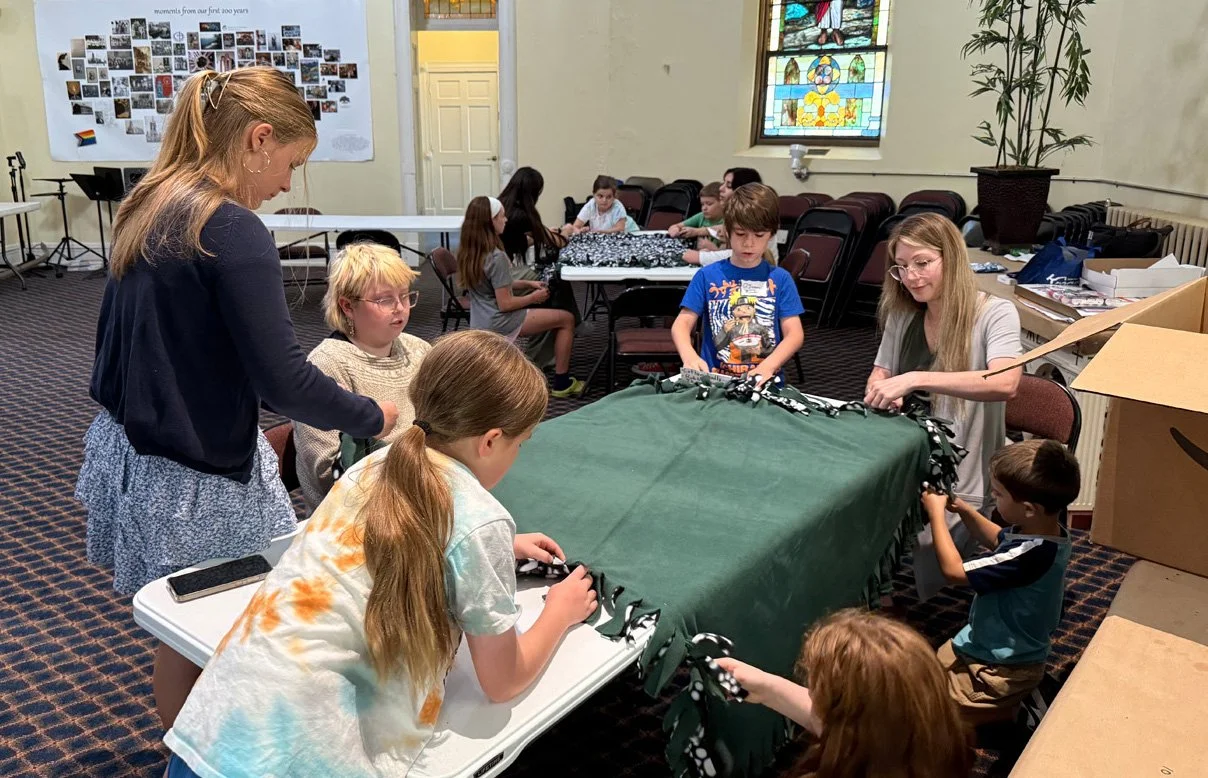 Children making blankets to give to children who need them