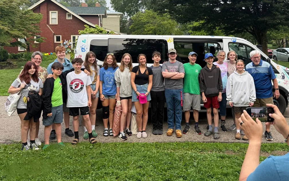 Youth in front of van ready to go to camp