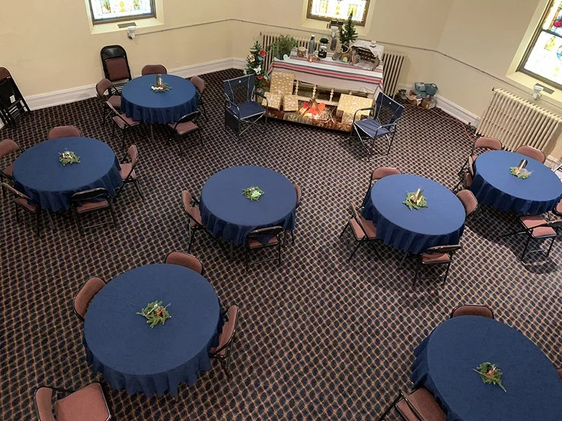 Tables set up in chapel for a meal