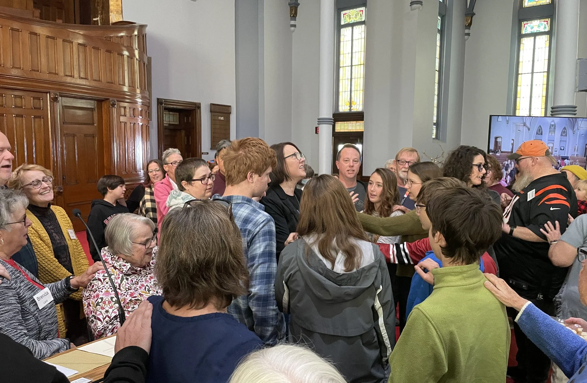 People gathered around pastor to pray and send her to Palestine in 2024