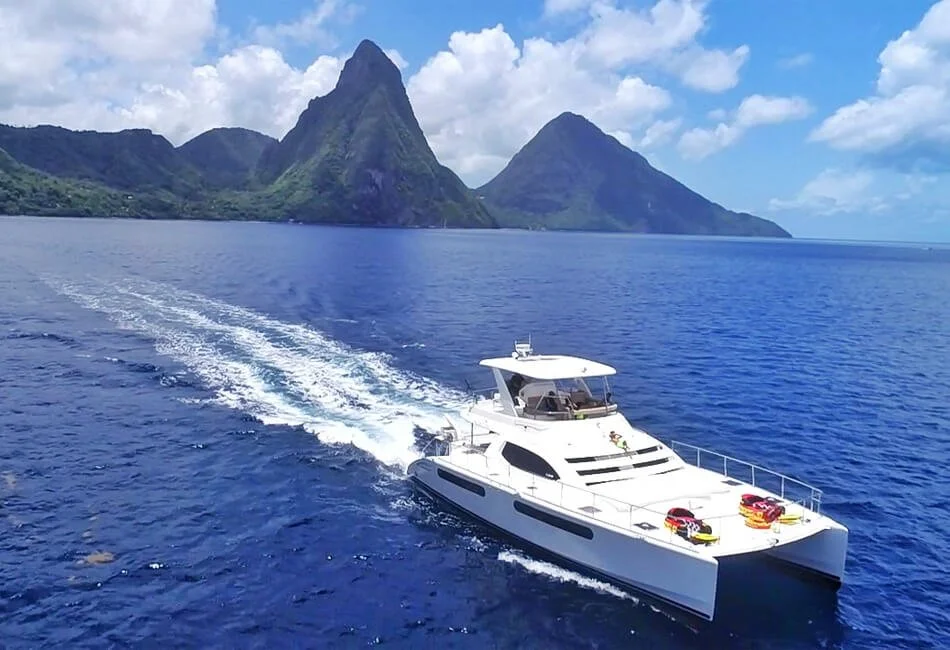 Catamaran sailing along the St. Lucia coastline toward the Piton mountains