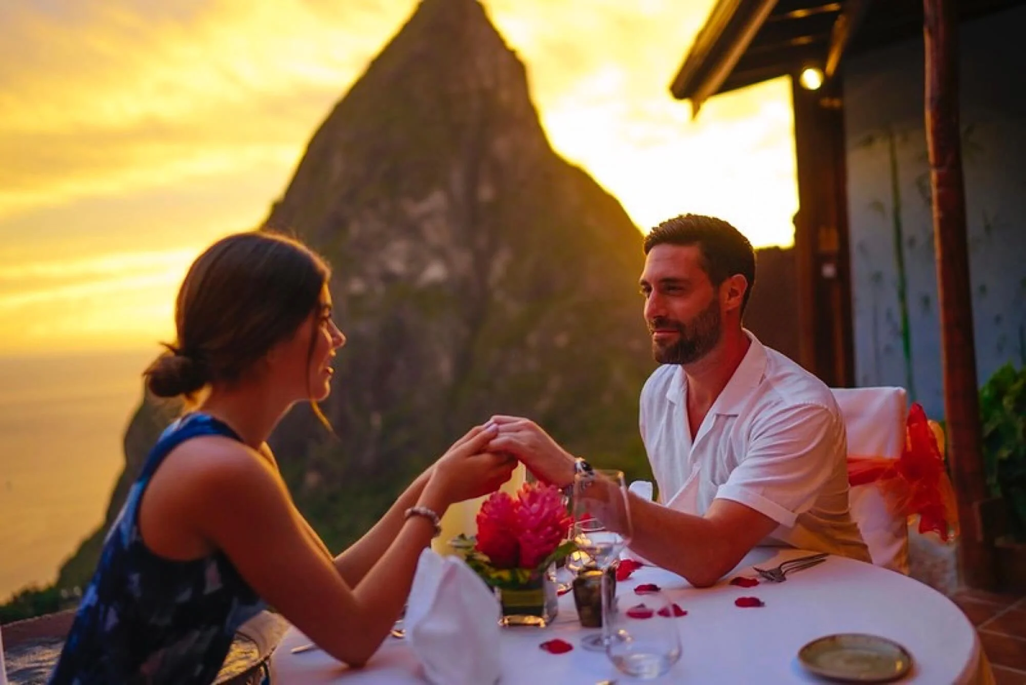 Couple at dinner in St. Lucia in front of Piton.