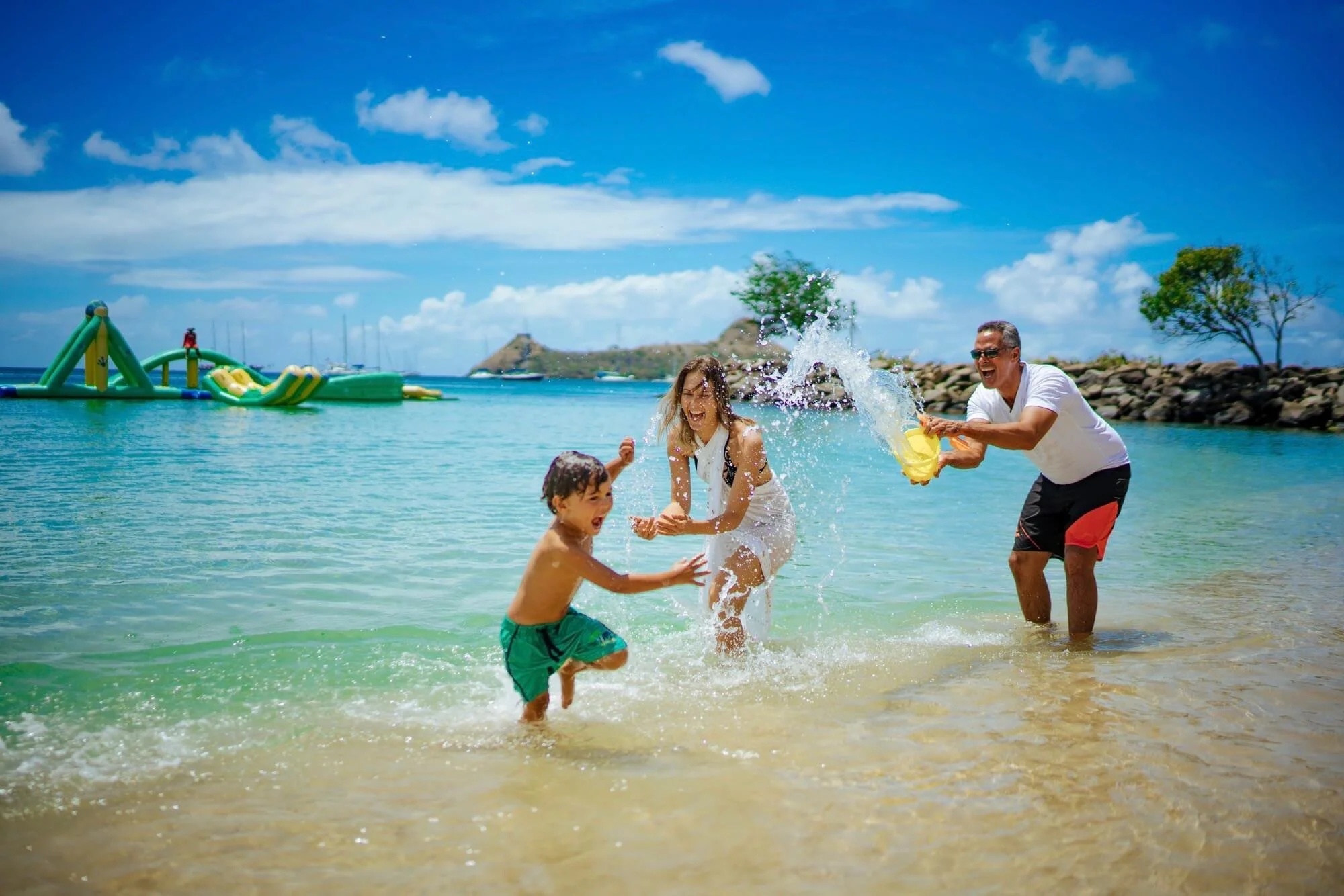Family splashing in the ocean.