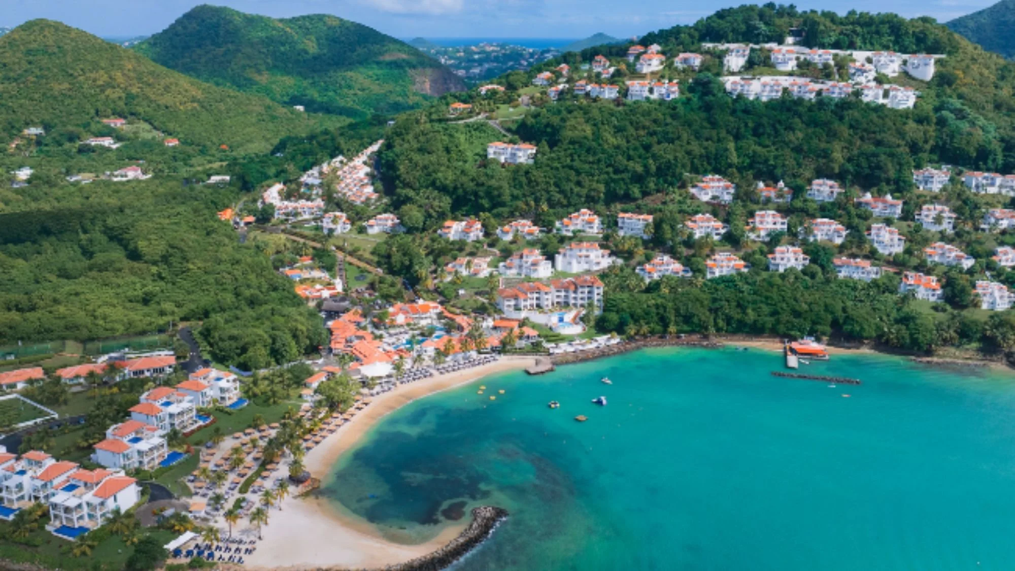 Villa resort on a tropical hillside overlooking a bay in St. Lucia