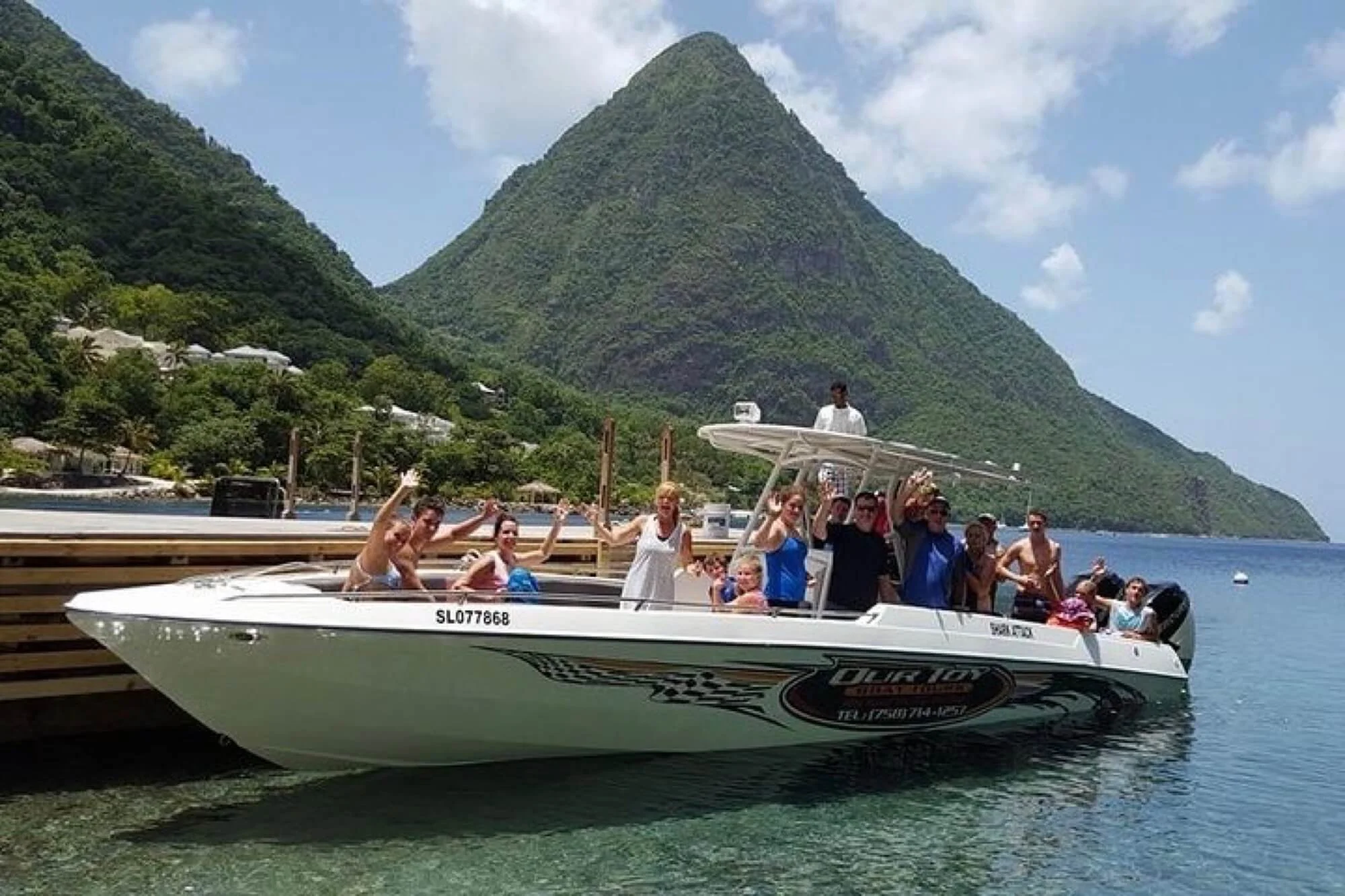 Boat filled with travelers ready for a land and sea tour.