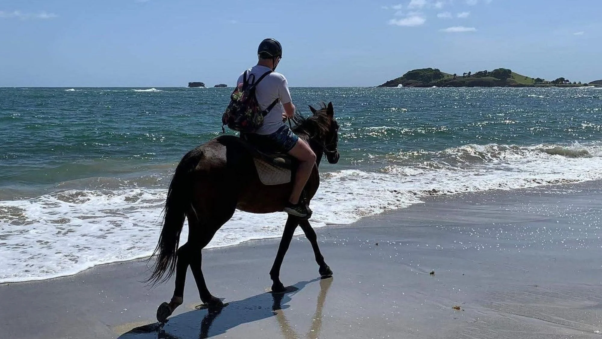 Man riding horse on beach in St. Lucia