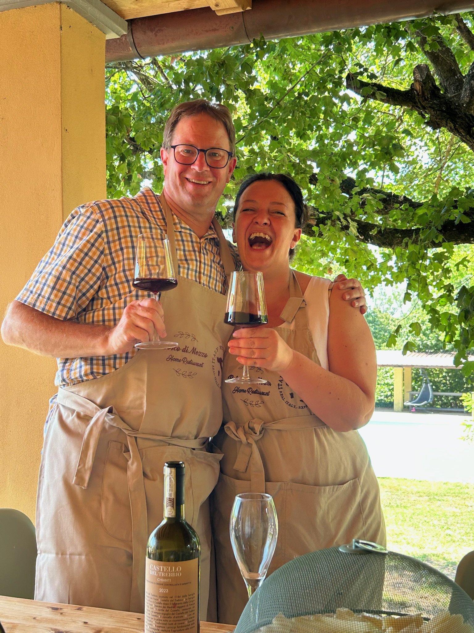 cooking class in florence - man smiling holding glass of wine