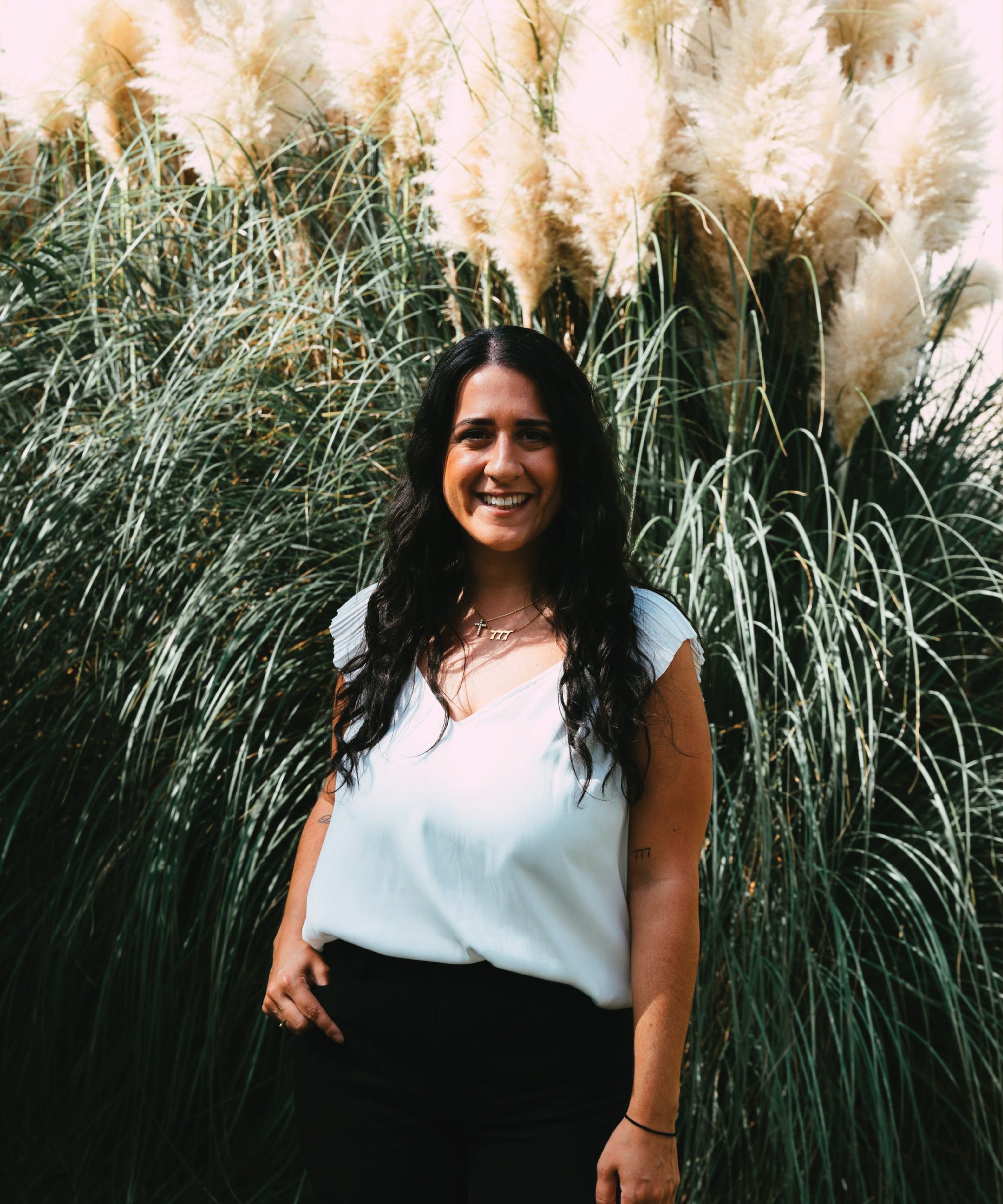 Woman with long dark hair smiling