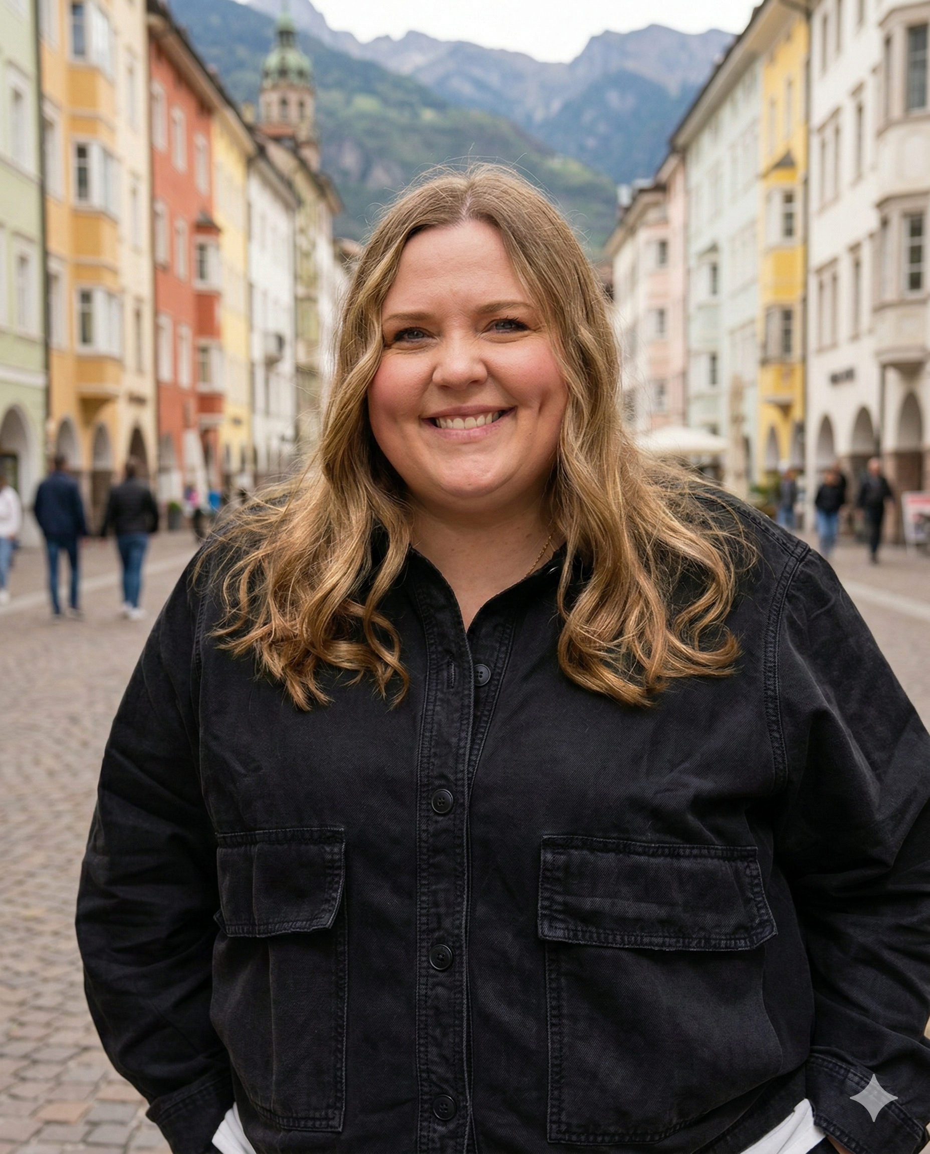 woman smiling with long hair standing in street in Bolzano, Italy