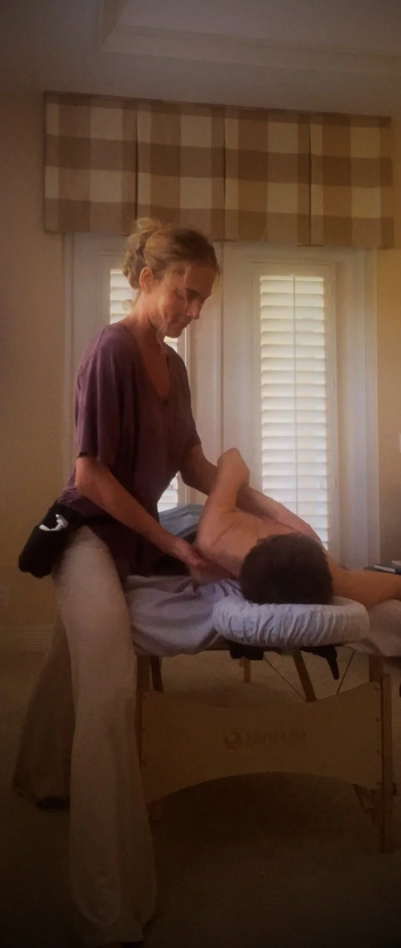 A woman receiving a massage and bodywork from Jillian Lacasse, LMT. At Spirit Well Sensory Lounge in Stuart, Florida. 