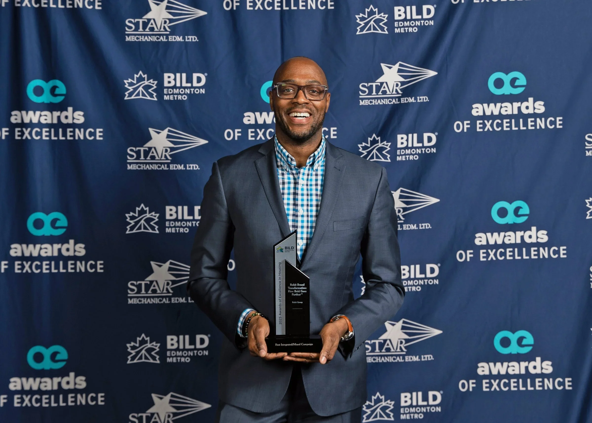 Nathan K. Walters at the BILD Awards of Excellence, showing the recently accepted award for best marketing; at the Edmonton Convention Centre