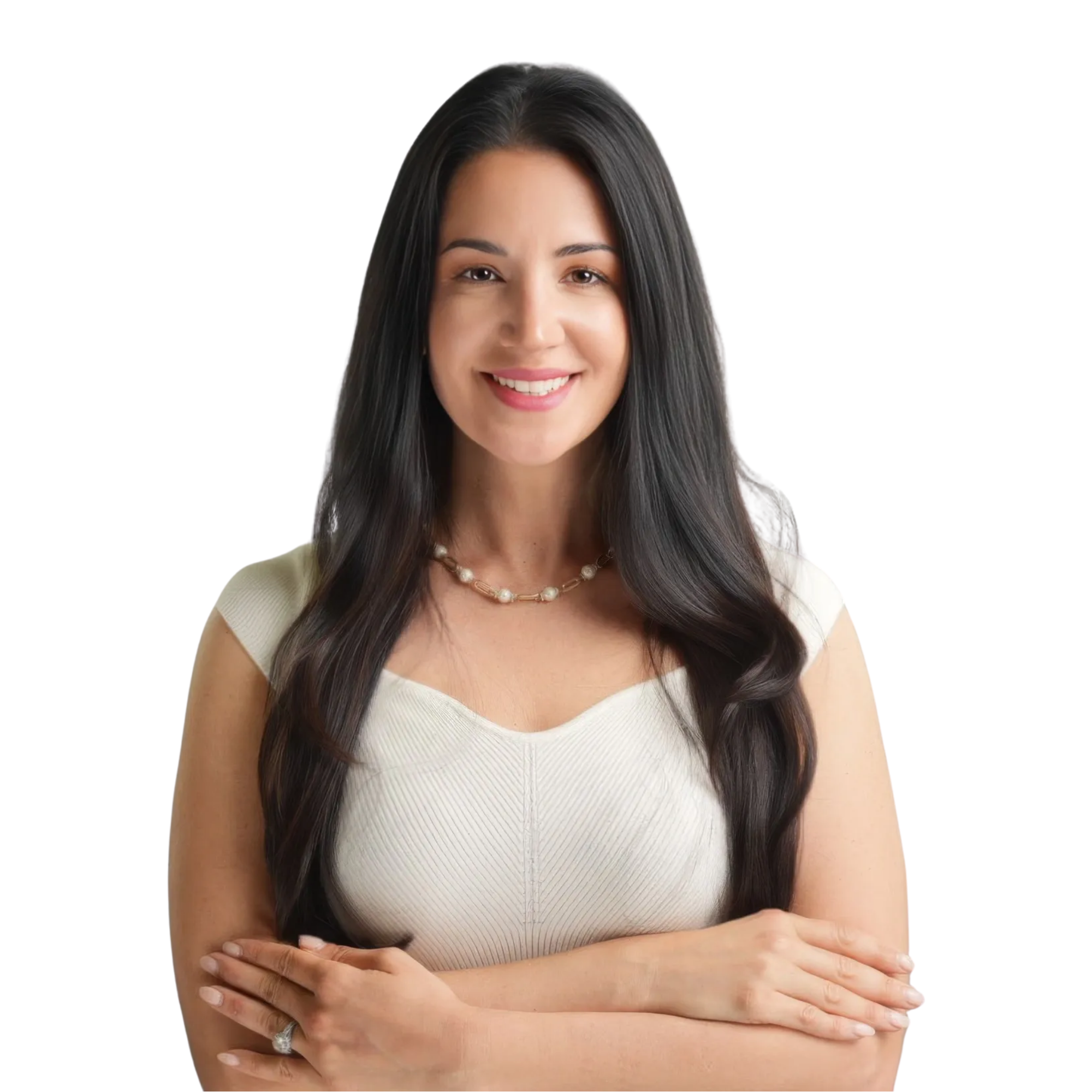 Portrait of a woman with long dark hair smiling, wearing a cream-colored sleeveless top and a pearl necklace, standing with arms crossed.