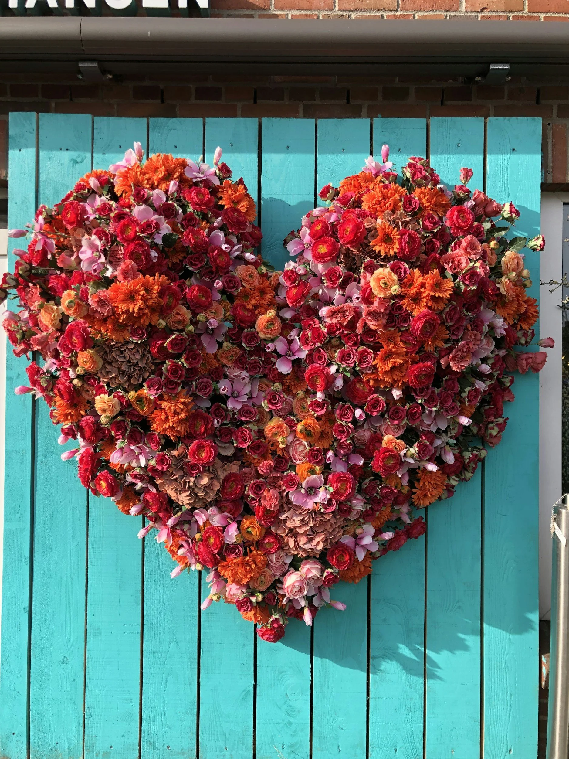 blue float with red heart made out of flowers sitting on top