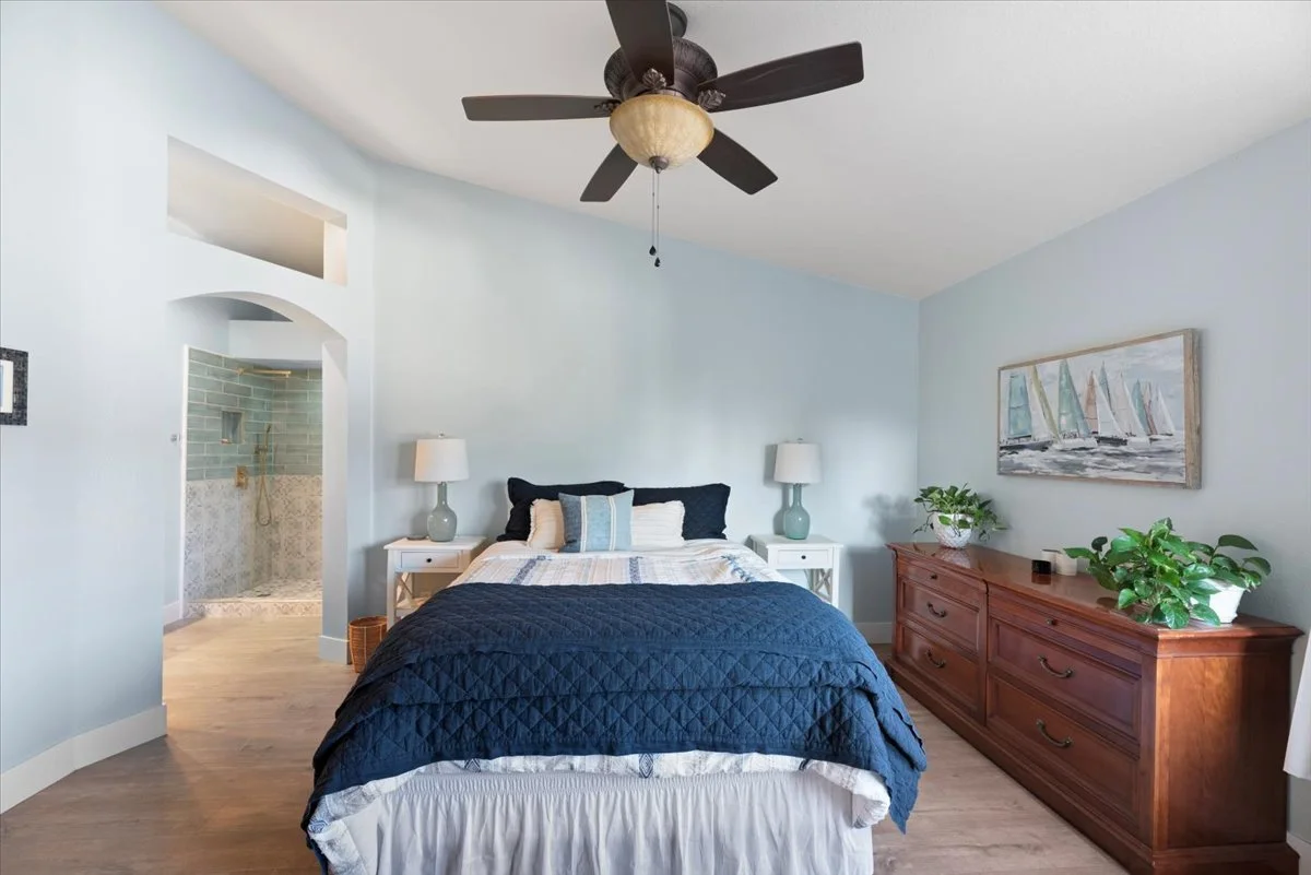 Primary bedroom with arched bathroom entry real estate photography Ontario CA SoCal Home Photo