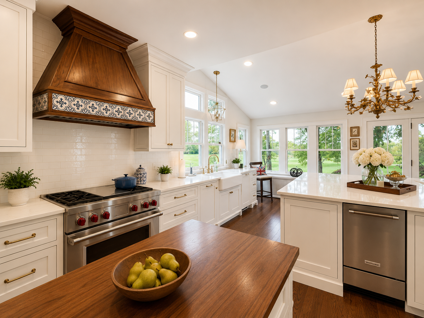Bright kitchen with white cabinets, a wooden range hood, stainless steel stove with red knobs, a farmhouse sink near large windows, and hardwood floors.