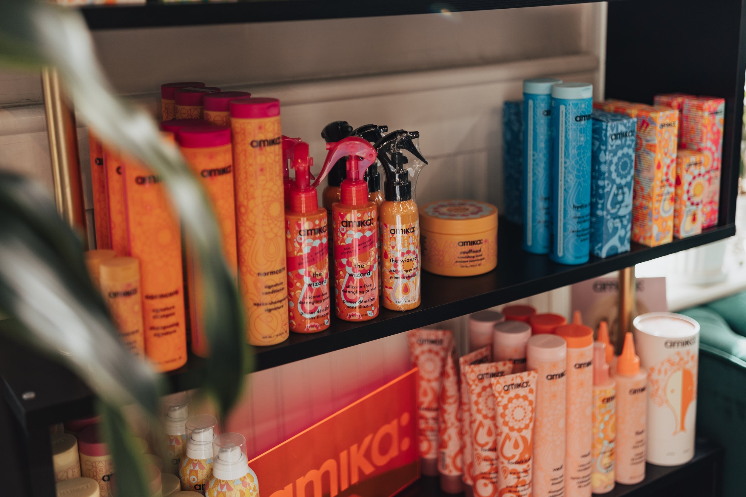Shelves displaying colorful skincare products with orange, pink, and blue packaging.