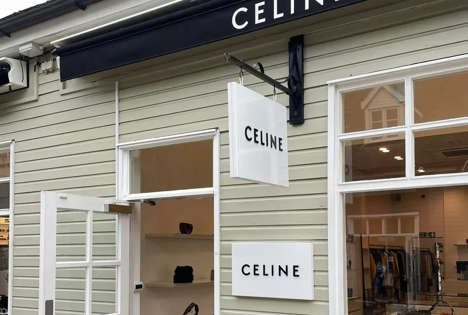 Exterior of a Celine store with signs displaying the brand name and open doorway showing inside retail space.