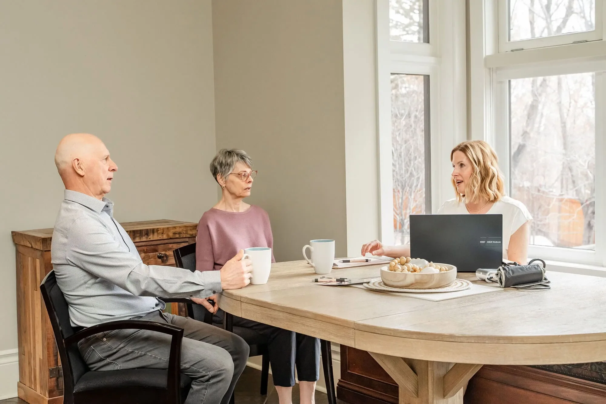 Caregiver discussing palliative care options with older adults at home