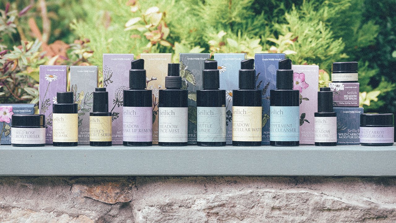 entire seilich skincare range design by studio creates on wall with greenery