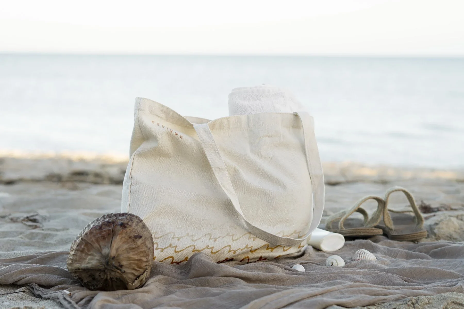 branding for revivre swimwear applied to cotton tote bags
