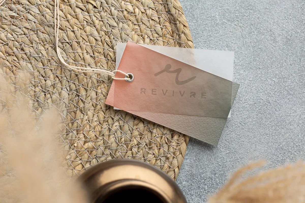 logo design on clothing swing tags for revivre swimwear