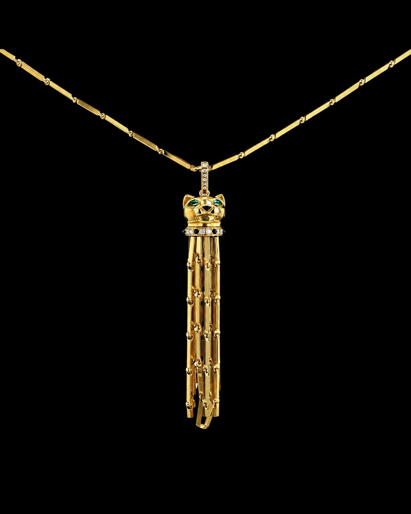 Cartier Panth&egrave;re long necklace in yellow gold emerald, and in onyx, delicately set with brilliant cut diamonds, composed of one panther in yellow gold, delicately set with 2 pear-cut emerald and onyx, decorated with patterns in black lacquer, 