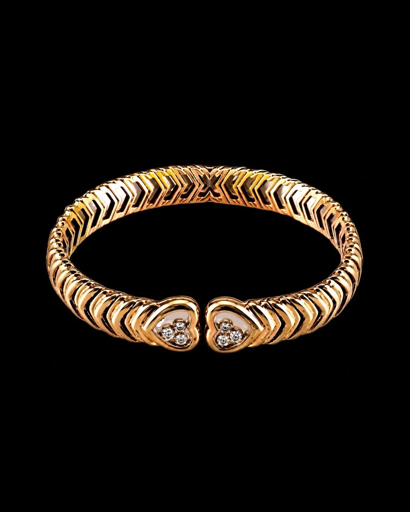 Chopard bangle
18k (750) gold, heart-shaped bangle ends, glazed, each with three brilliant-cut diamonds in movable bezel settings, totaling. 6.36 carats.

Weight 61.5g.