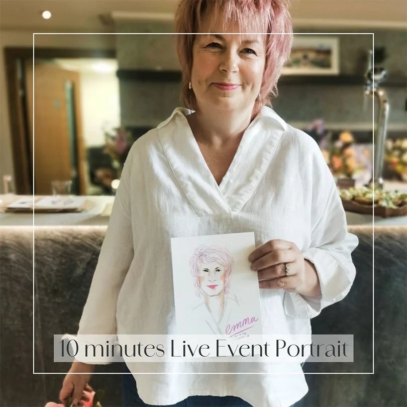 A short pink-haired lady wearing a white top, holding a personalised fashion portrait illustrated by Siya Liu at a live event.  