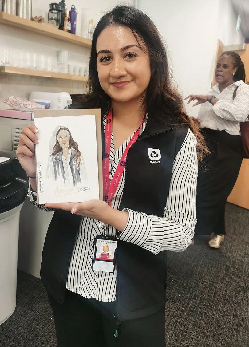 An Asian ethnic woman with long hair holding up a quick portrait by Siya Liu at the NatWest Event. 