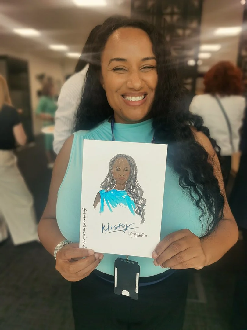 A Black woman with long, wavy black hair is holding up a quick portrait by Siya Liu at the NatWest Event. 