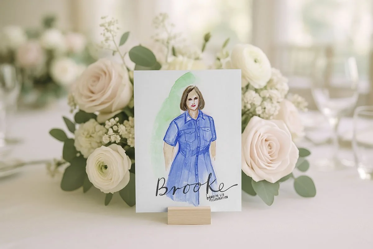 A fashion illustration of a lady in a navy blue dress, named Brooke, works as a luxury event or wedding place card and keepsake, hand-illustrated by Siya Liu, Live Event Artist at a live event.