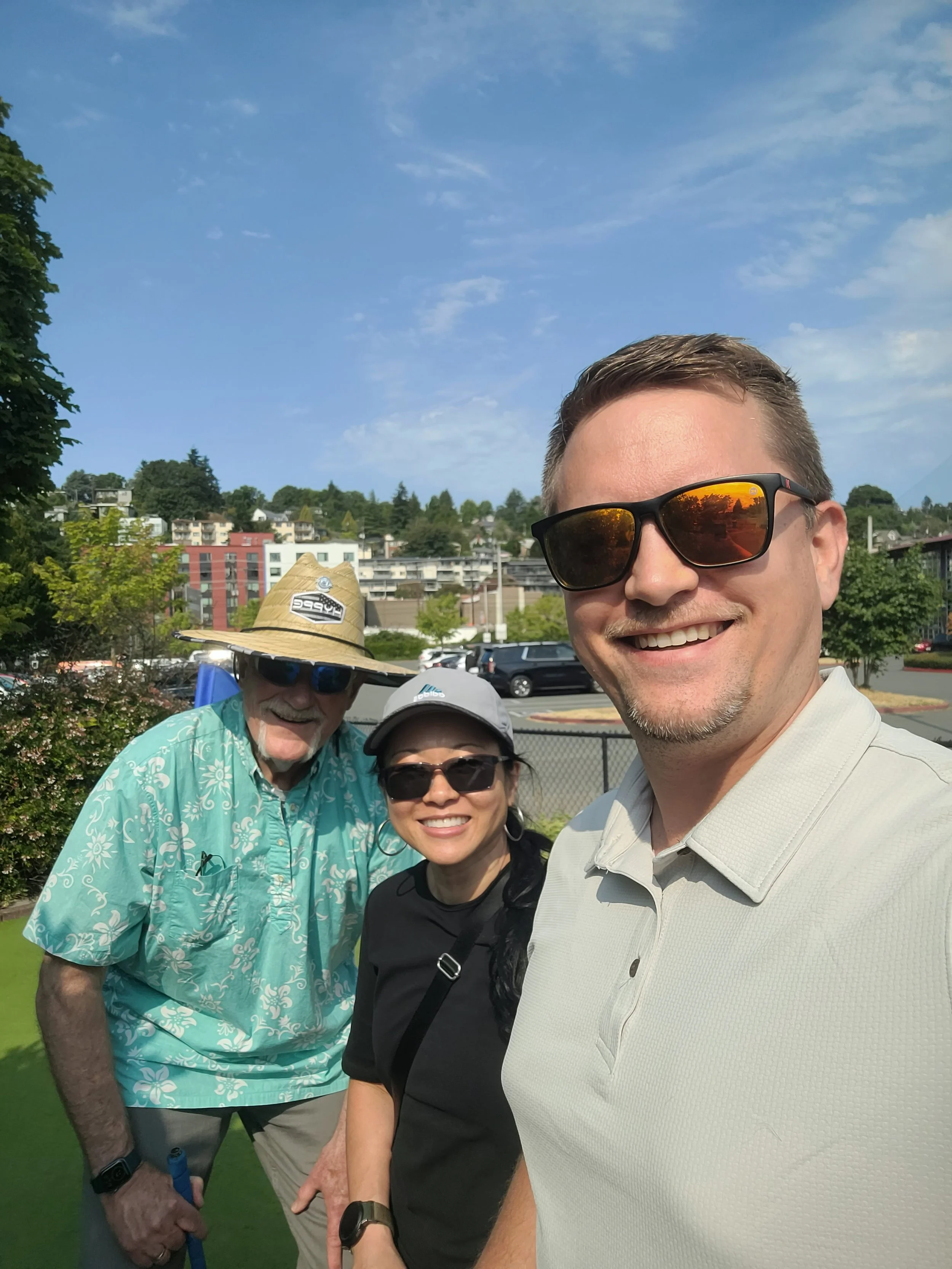 Paul Butler, Vy Duong, and Drew Gillespie of USI smile on the Putt Putt course.