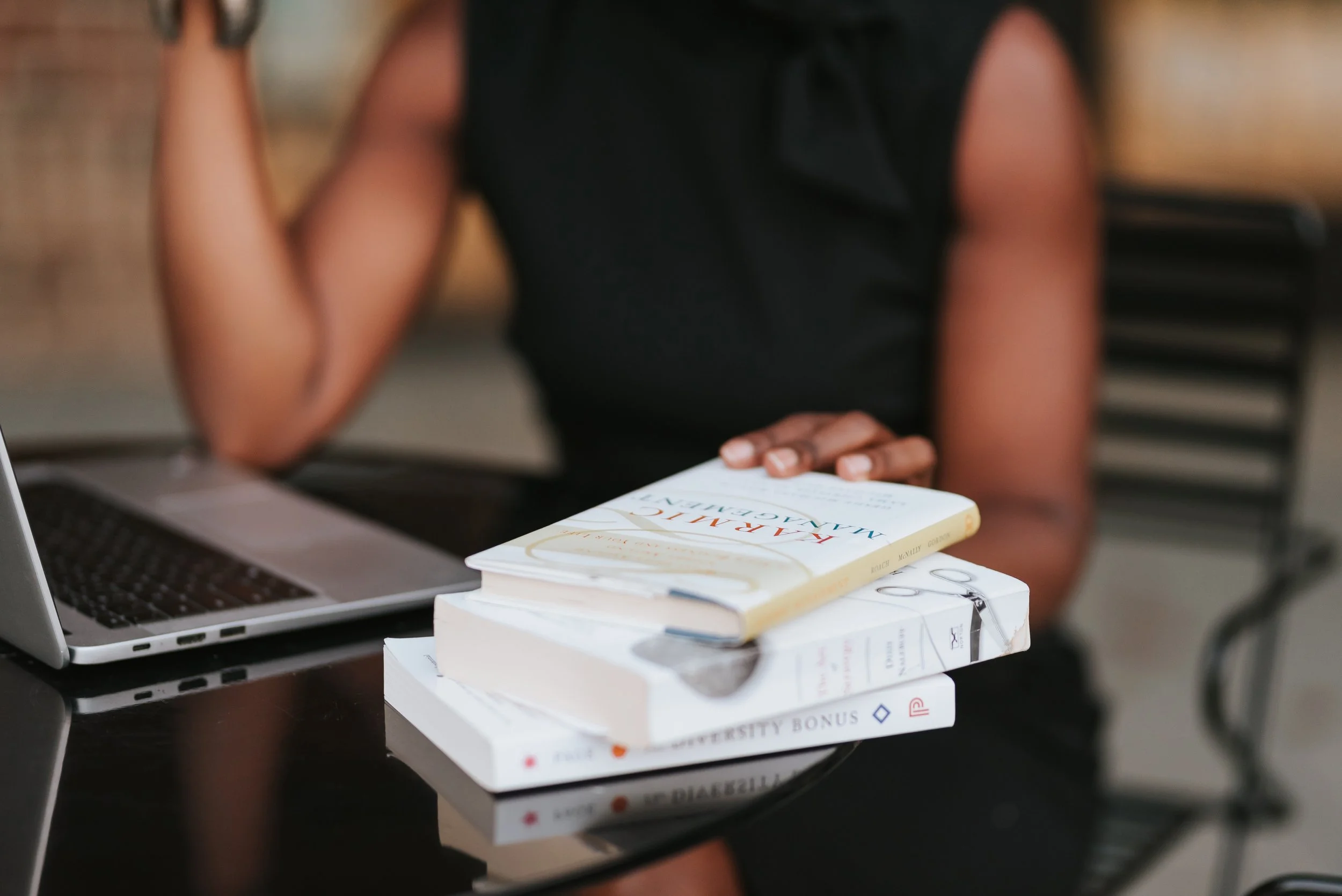 stack of personal development books for executives